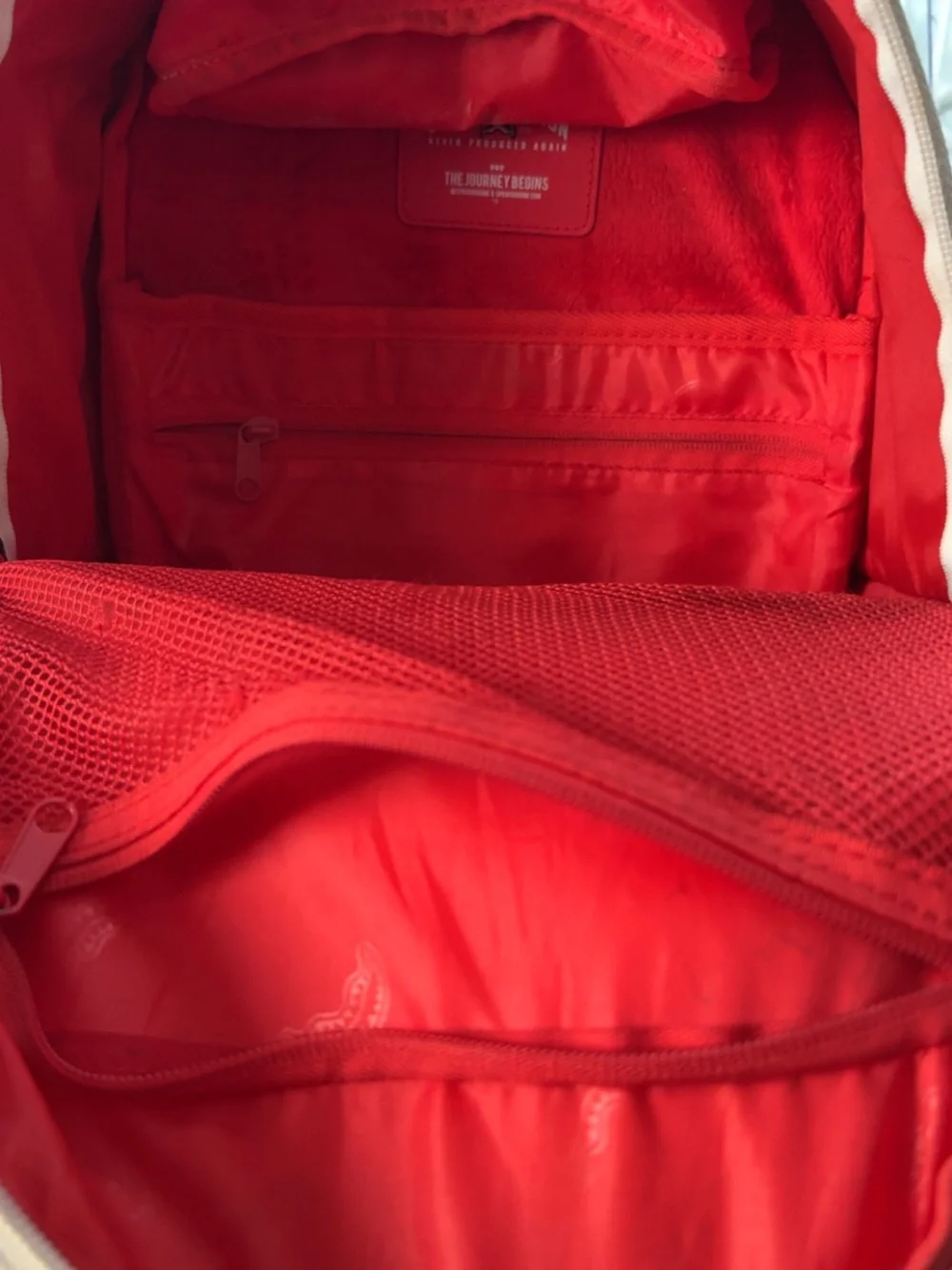 Sprayground Grey Camo Backpack with Red Zip Accent